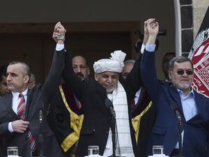 Afghan President Ashraf Ghani (C) holds hands with first vice-presidents Amrullah Saleh (L) and second vice president Sarwar Danish during his swearing-oath inauguration ceremony as the country's leader, at the Presidential Palace in Kabul on March 9, 2020. Afghanistan lurched deeper into political crisis on March 9 as the rivals for the country's leadership had themselves sworn in at simultaneous ceremonies that were interrupted by at least two blasts. WAKIL KOHSAR / AFP