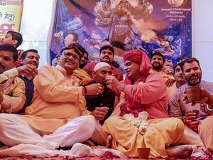 Hindu organisation 'Akhil Bharat Hindu Mahasabha' president Chakrapani Maharaj (2R) makes a supporter (C) drink panchagavya, a traditional Hindu ritual mixture made of cow dung, urine, milk, curd and ghee as they attend a 'gaumutra (cow urine) party' to fight against the spread of the COVID-19 coronavirus, in New Delhi on March 14, 2020. Jalees ANDRABI / AFP