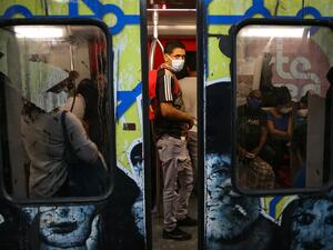 People travel on the subway wearing protective masks as a preventive measure in the face of the global COVID-19 coronavirus pandemic, in Caracas, on March 14, 2020. AFP/ File