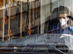 A bus driver wearing a protective mask as a precaution against COVID-19 coronavirus disease operates a bus in Iran's capital Tehran on March 15, 2020. STRINGER / AFP