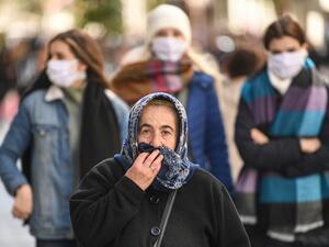 People wear protective face masks as they walk along Istiklal Avenue as the nation tries to contain the novel coronavirus, COVID-19, in Istanbul on March 17,2020. AFP/File
