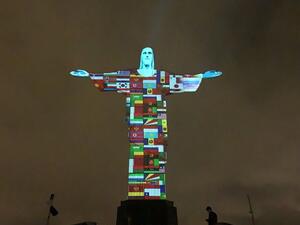 Flags of the countries affected by the spread of the new coronavirus, COVID-19, are prjected on the statue of the Christ Redemeer atop Corcovado hill in Rio de Janeiro, Brazil, on March 18, 2020. AFP