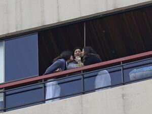 Young girls kiss their mother who just received a rose delivered to her via a drone on Mother's day, in the Lebanese coastal city of Jounieh, north of the capital Beirut on March 21, 2020, as people remain indoors in an effort to limit the spread of the novel coronavirus. In a quiet Lebanese town under lockdown over the novel coronavirus, a drone buzzed towards a balcony on Saturday to deliver a red rose to a mother grinning in surprise. The COVID-19 pandemic may have put a damper on Mother's Day this year,