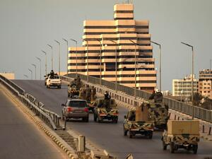 Fighters of a military battalion loyal to Libyan General Khalifa Hafta patrol the streets in the eastern city of Benghazi during a state of emergency to combat the coronavirus disease (COVID-19) outbreak, on March 21, 2020. Abdullah DOMA / AFP