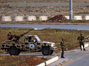Fighters of a military battalion loyal to Libyan General Khalifa Hafta patrol the streets in the eastern city of Benghazi during a state of emergency to combat the coronavirus disease (COVID-19) outbreak, on March 21, 2020. Abdullah DOMA / AFP