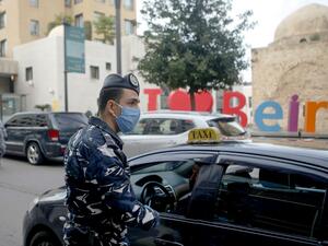 A Lebanese security officer mans a checkpoint to implement a curfew on motorcycles and vehicles with more than two passengers in the capital Beirut, on March 23, 2020, amid lockdown measures to curb the spread of the coronavirus epidemic. PATRICK BAZ / AFP