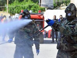 Civil defense teams disinfect a seminary in the city of Najaf where Islamic students are believed to have come in contact with Iraq's first confirmed case of novel coronavirus | AFP