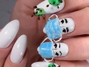Dailonsy Nails, from Miami, shared their design which features a set of white acrylics and 3D replicas of medical masks and the virus  (Instagram)