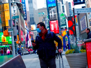 A man visits Times Square as he wears a face mask on March 8, 2020 in New York City, (AFP)