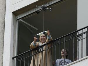Under lockdown over coronavirus, a drone buzzed towards a balcony on Saturday to deliver a red rose to a mother grinning in surprise. Three students have come up with a new service to celebrate the occasion without social restriction (Twitter)