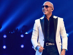 The clip shows the entertainer dancing on a rooftop with the Miami skyline behind him.