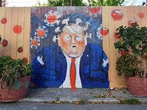 A mural painted on a fence depicts US President Donald Trump as the Coronavirus in San Francisco, California on April, 01, 2020. All 40 million residents of California were Thursday ordered to stay at home indefinitely in a bid to battle the coronavirus pandemic in the nation's most populous state. Josh Edelson / AFP