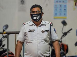 A police personnel wears a facemask as he stands on a street during a government-imposed nationwide lockdown as a preventive measure against the COVID-19 coronavirus, in Siliguri on April 2, 2020. DIPTENDU DUTTA / AFP