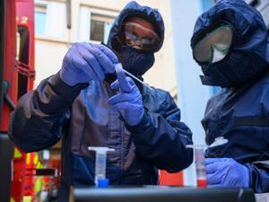 French firefighters from Marins Pompiers unit of Marseille wearing protective equipments as they working at the PCR machine on a mobile unit, which can detect the presence of SARS-CoV-2 in the environment after prelevment in Marseille on 03 April, 2020, during the strict lockdown in France to stop the spread of the novel coronavirus. AFP