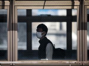 A man wearing a face mask amid concerns over the spread of the COVID-19 coronavirus walks in Shinagawa station in Tokyo on April 6, 2020. Behrouz MEHRI / AFP