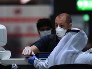 Passengers have their travel documents checked before departure at Dubai International Airport in the gulf emirate on April 6, 2020, as Emirates airline resumed a limited number of outbound passenger flights after its COVID-19 coronavirus-enforced stoppage. KARIM SAHIB / AFP