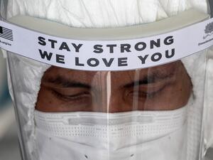 A health worker wearing a protective suit prepares to enter two apartment buildings in Kuala Lumpur on April 8, 2020, after they were cordoned off due to a number of cases of individuals with COVID-19 novel coronavirus at the premises. Mohd RASFAN / AFP