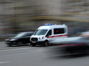 An ambulance drives along a street in Moscow on April 10, 2020. Moscow's hospitals and ambulance service are working at peak capacity after a sharp rise in those hospitalised with serious coronavirus complications, a senior city official said on April 10. Kirill KUDRYAVTSEV / AFP