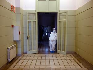 A healthcare worker wearing a protective suit waits during a COVID-19 coronavirus testing campaign at the Hospital Sant Miquel care home for the elderly in Barcelona on April 15, 2020. Spain recorded 523 deaths from the coronavirus on Wednesday, a decline from the previous day, but the number of new daily confirmed cases was the highest in six days. LLUIS GENE / AFP