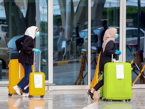 Kuwaiti nationals, residing abroad, leave the Kuwait International airport in the capital upon their return as part of a repatriation plan on April 19, 2020, and ahead of being taken to mandatory home quarantine. YASSER AL-ZAYYAT / AFP