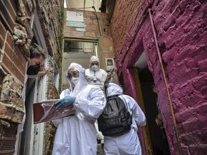 Workers of Bogota's Mayor's office wear protective suits to avoid getting infected with COVID-19 as they conduct a census at Egipto (Egypt) neighbourhood in Bogota on April 19, 2020 to know how many families need to be provided with food to prevent them from go shopping during the new coronavirus pandemic. The number of coronavirus infections across Latin America surpassed 100,000 on Sunday with nearly 5,000 deaths, according to an AFP tally based on official figures reported by individual countries. Diana 