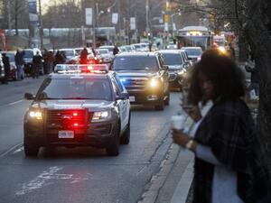 A convoy of Toronto Police vehicles is seen as Toronto first responders parade down hospital row in Toronto, Ontario, Canada, in a salute to healthcare workers on April 19, 2020, amid the novel coronavirus pandemic. (AFP)