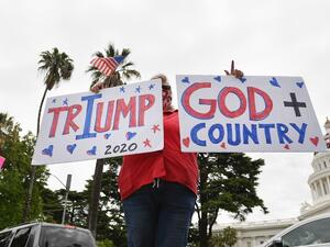 Some people intentionally jammed roads while honking and holding out signs while others disrespected social distancing rules by gathering in close proximity, blaring Americana music and shouting to end the lockdown. Josh Edelson / AFP
