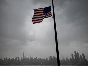 An US flag flies at half-mast half mast in front of the Skyline of Manhattan of New York City seen from Weehawken, New Jersey, on April 21, 2020. Over 2.5 million people have been confirmed to have contracted the coronavirus worldwide, with 80 percent of cases in Europe and the United States, according to an AFP tally Tuesday based on official figures. Johannes EISELE / AFP