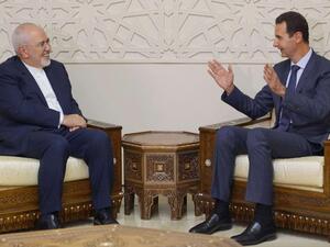 Iran's Foreign Minister Mohammad Javad Zarif (L) meeting with Syrian President Bashar al-Assad (R) in Damascus on September 3, 2018. (AFP)