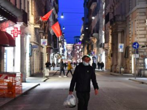 Deserted Via del Corso in Rome. Photograph: Tiziana Fabi/AFP
