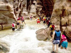 A group of adventurers battle raging waters at Wadi Mujib. (Credit: Wild Jordan)