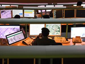 Police officers monitor the streets and receive calls from citizens at the Command and Control Center of Dubai Police in the Gulf emirate, on February 24, 2020. The novel coronavirus has given the Gulf emirate of Dubai an opportunity to showcase its technological and scientific clout as it seeks to shape its own model for approaching the pandemic. KARIM SAHIB / AFP