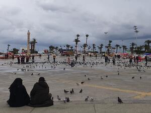 Libyans sit at Martyrs square in the capital Tripoli on March 10, 2020. According to Libyan authorities, not a single case of coronavirus so far has been recorded in the country which faces Italy across the Mediterranean. (AFP/File)