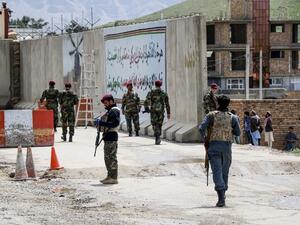 Security personnel gather near a military outpost at the site where a suicide bomber attack occurred, on the outskirts of Kabul on April 29, 2020. A suicide bomber killed at least three people and wounded 15 others after detonating explosives near a military outpost in Kabul on April 29, an official confirmed, in the first attack to rock the Afghan capital in weeks. STR / AFP