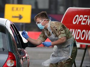 A soldier from 2 Scots Royal Regiment of Scotland tests a key worker for the novel coronavirus Covid-19 at a drive-in testing centre at Glasgow Airport on April 29, 2020, as the UK continues in lockdown to help curb the spread of the coronavirus. Andrew Milligan / POOL / AFP