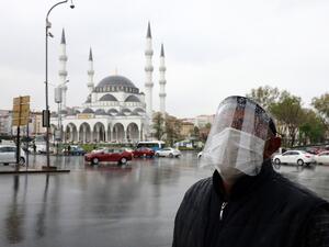 A man wearing a face-shield for protective measures crosses the streets as the spread of the COVID-19, the novel coronavirus continues in Ankara, on April 30, 2020. Adem ALTAN / AFP