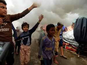 Yemeni children react as municipal workers fumigate a street in the old city market of the capital Sanaa, with a disinfectant substance against the novel coronavirus, on April 30, 2020. Yemen has been largely spared from the effects of the pandemic, with a total of six cases recorded so far -- the first in April in the government-controlled southeastern province of Hadramawt. Mohammed HUWAIS / AFP