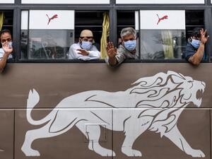 Native Kashmiri passengers wave from the windows of a special service bus about to leave for Jammu and Kashmir state during a government-imposed nationwide lockdown as a preventive measure against the COVID-19 coronavirus, in Amritsar on May 3, 2020. NARINDER NANU / AFP