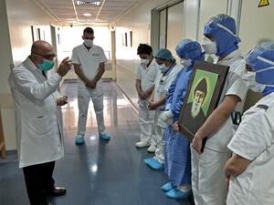 A picture taken by a nurse on April 9, 2020 at the Hotel Dieu de France Hospital, colleagues gathered for a prayer guided by a priest in the coronavirus COVID-19 section of the hospital, in the neighbourhood of Ashrafieh of the Lebanese capital Beirut's eastern suburbs. (AFP)