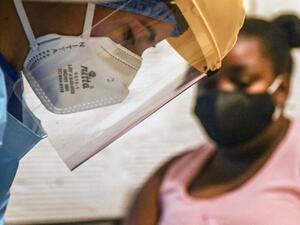 A health worker prepares to take a sample for a COVID-19 test at a patient's home in Medellin, Colombia on May 8, 2020. JOAQUIN SARMIENTO / AFP