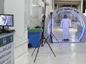 A man passes through a self-sterilisation gate set up at an entrance of the Kaaba and the Grand Mosque, as a preventive measure amid the the COVID-19 pandemic during the Muslim month of Ramadan in the Saudi holy city of Mecca, on May 8, 2020. (STR / AFP)