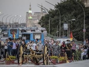 Members of the Egyptian security forces wearing masks against the coronavirus Covid-19 prepare to fire a Ramadan cannon to mark the breaking of the fasting during the Muslim holy month of Ramadan at Giza district in the Egyptian capital Cairo on May 7, 2020. Khaled DESOUKI / AFP