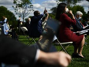 Reporters wearing masks ask questions as US President Donald Trump speaks during a news conference on the novel coronavirus, COVID-19, in the Rose Garden of the White House in Washington, DC on May 11, 2020. Brendan Smialowski / AFP