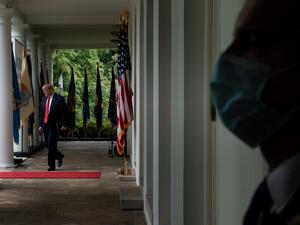 A member of the Secret Service wears a surgical mask as US President Donald Trump arrives for a news conference on the novel coronavirus, COVID-19, in the Rose Garden of the White House in Washington, DC on May 11, 2020. Brendan Smialowski / AFP