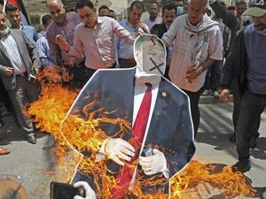 Palestinian men burn a cardboard cutout of US Secretary of State Mike Pompeo during a protest against his visit to Israel, on May 14, 2020 in Nablus in the occupied West Bank. Pompeo landed in Tel Aviv the day before for talks on regional security and Israel's plans to annex parts of the occupied West Bank, a pool report said. JAAFAR ASHTIYEH / AFP