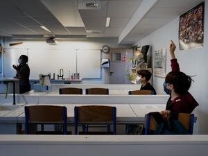 Schoolchildren wearing protective face masks attend a lesson in a middle school classroom, on May 18, 2020 in Lyon, central eastern France, after France eased lockdown measures to curb the spread of the COVID-19 pandemic, caused by the novel coronavirus. JEFF PACHOUD / AFP