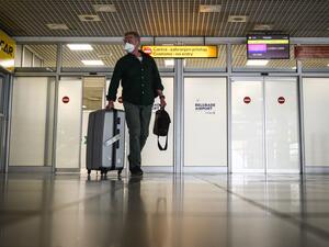 A passenger from London arrives at Belgrade's airport on May 18, 2020. With limited number of flights, air travel has resumed at Serbia's main airport after the authorities approved the airport to gradually resume operations with new guidelines amid the COVID-19 pandemic. Only passengers with tickets are allowed into the airport building four hours ahead of their flight. Andrej ISAKOVIC / AFP