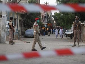 Security personnel patrol on a cordon off a street a day after a Pakistan International Airlines aircraft crashed in a residential area in Karachi on May 23, 2020. Ninety-seven people were killed and two survived when a passenger plane crashed into homes in Pakistan's southern city of Karachi, health officials said on May 23. Asif HASSAN / AFP