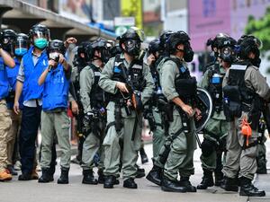 Riot police gather on a road as protesters take part in a pro-democracy rally against a proposed new security law in Hong Kong on May 24, 2020. The proposed legislation is expected to ban treason, subversion and sedition, and follows repeated warnings from Beijing that it will no longer tolerate dissent in Hong Kong, which was shaken by months of massive, sometimes violent anti-government protests last year. Anthony WALLACE / AFP