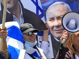 Israeli women shout slogans during a rally in support of Prime Minister Benjamin Netanyahu outside his residence in Jerusalem on May 24, 2020. (AFP/File Photo)